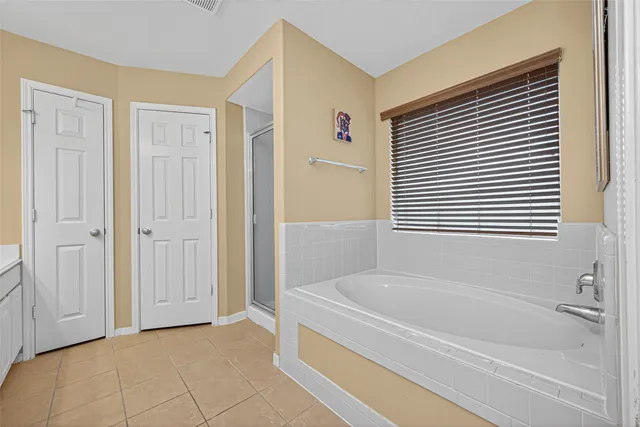 a bathroom with a bathtub and a shower