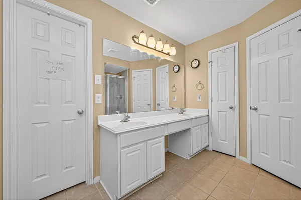 a spacious bathroom with a granite countertop sink and a mirror