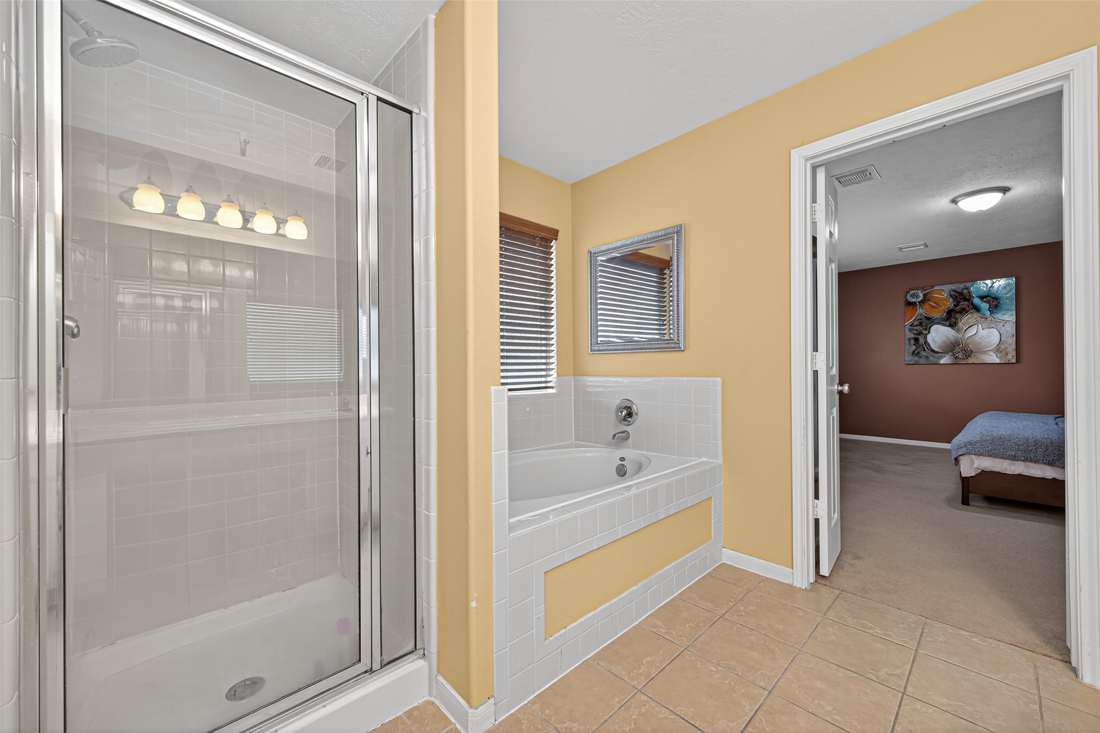 22402 Bridgestone Ridge Drive Spring, TX 77389 - Photo 29 of 49 a en suite bathroom with a tub shower and mirror