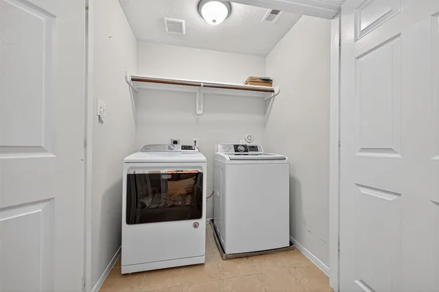 a utility room with dryer and washer