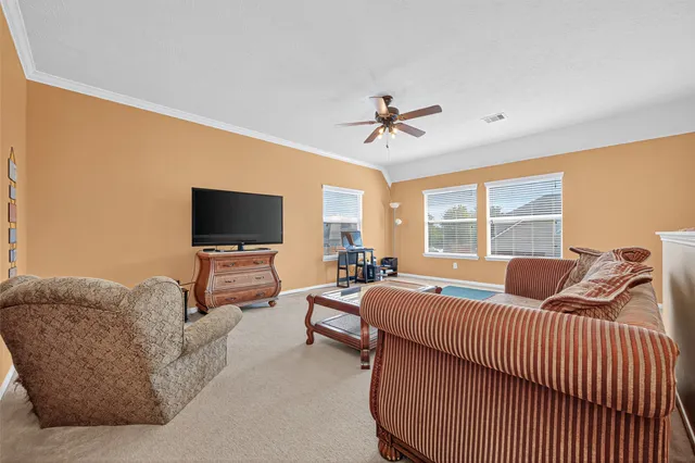 a bedroom with furniture and a flat screen tv