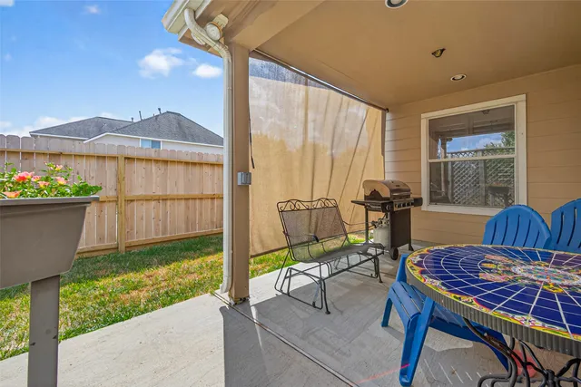 a view of a porch with furniture and a yard