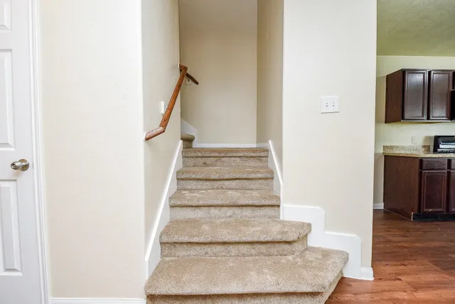 a view of entryway and hall with wooden floor