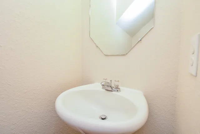 a bathroom with a sink and mirror