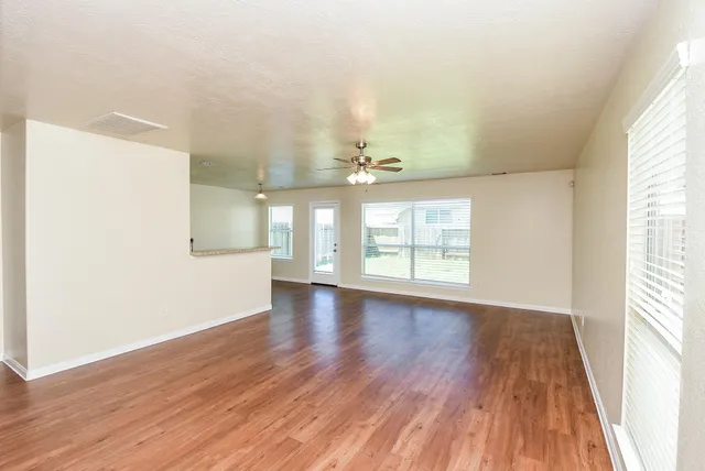 wooden floor in an empty room with a window