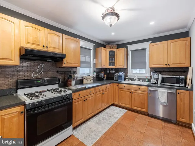 a kitchen with stainless steel appliances granite countertop a stove and a sink