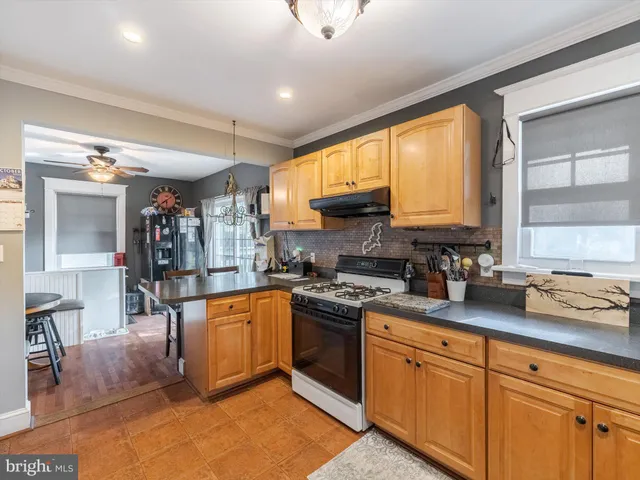a kitchen with stainless steel appliances granite countertop sink window and refrigerator