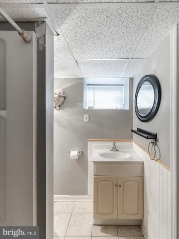 a bathroom with a sink vanity granite and a mirror