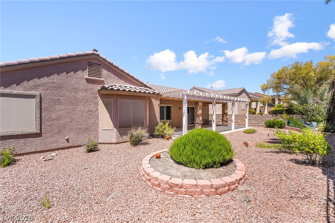 3033 Hartsville Road Henderson, NV 89052 - Photo 40 of 41 A private desert-scaped yard awaits, featuring a covered patio for outdoor enjoyment.