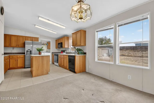 an empty room with closet and a ceiling fan