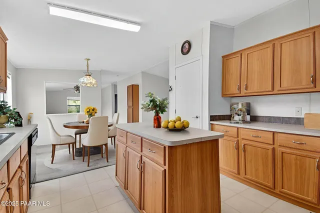 a view of a big room with a ceiling fan and a window