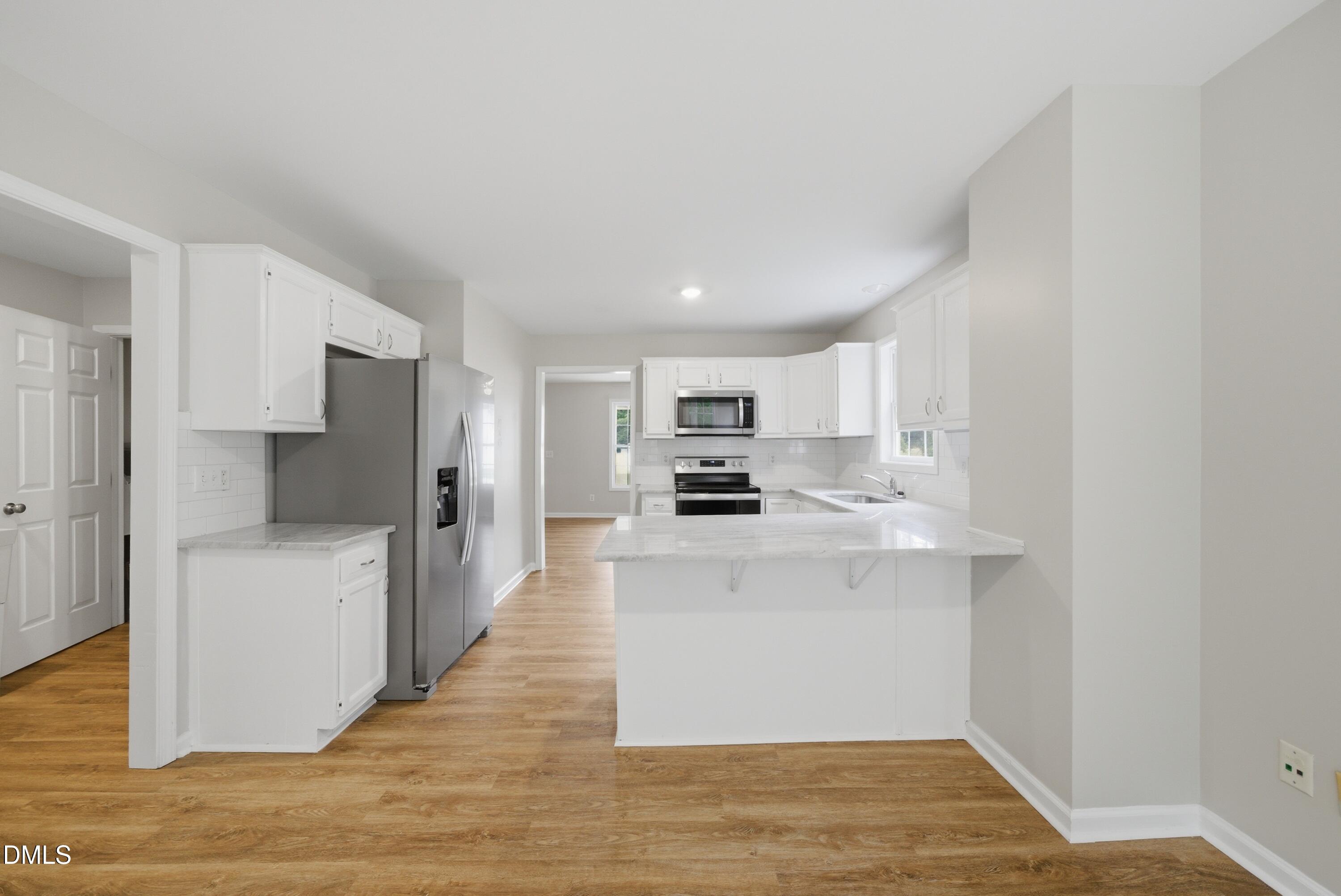 201 Tonylee Court, Unit A Raleigh, NC 27603 - Photo 14 of 30 a kitchen with stainless steel appliances a refrigerator and a stove top oven