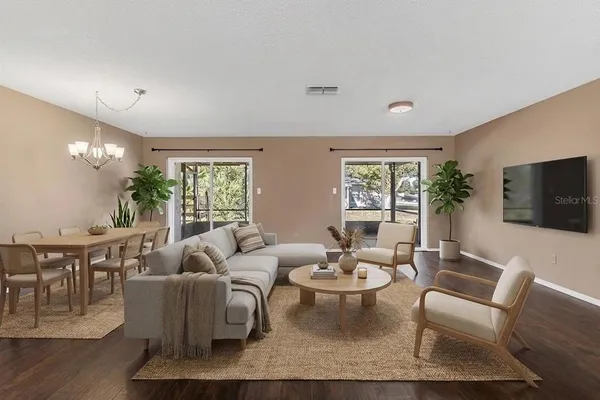 a living room with furniture a flat screen tv and a large window