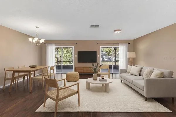 a living room with furniture a flat screen tv and a large window