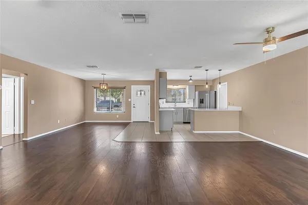 a view of kitchen and hall with wooden floor