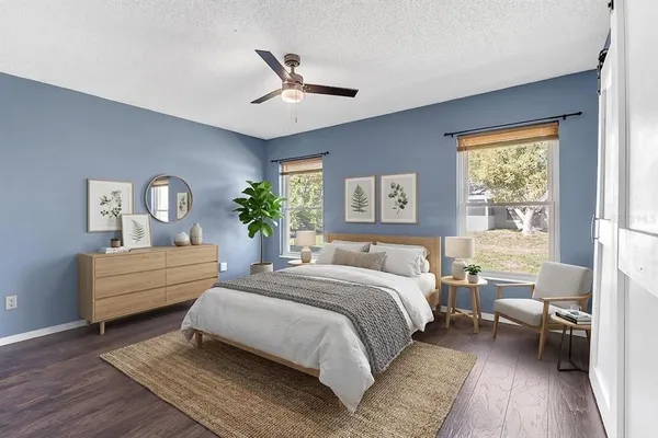 a bedroom with a bed wooden floor and window