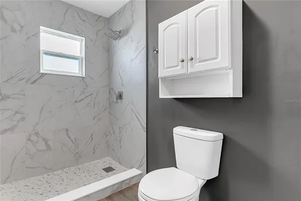 a white toilet sitting next to a bathroom sink