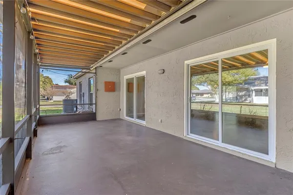 a view of a hall with wooden floor and a floor to ceiling window