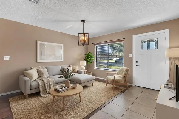 a living room with furniture and a chandelier