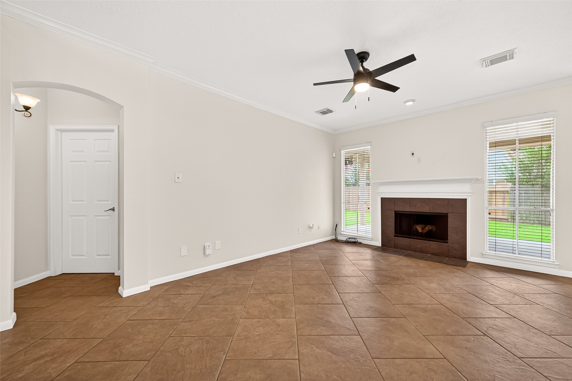 12831 Dove Point Lane Houston, TX 77041 - Photo 18 of 50 a view of an empty room with a fireplace and a window
