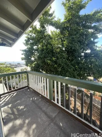 a view of a room with wooden floor and window