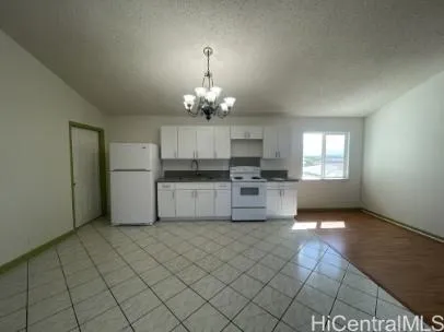 a large kitchen with cabinets and stainless steel appliances