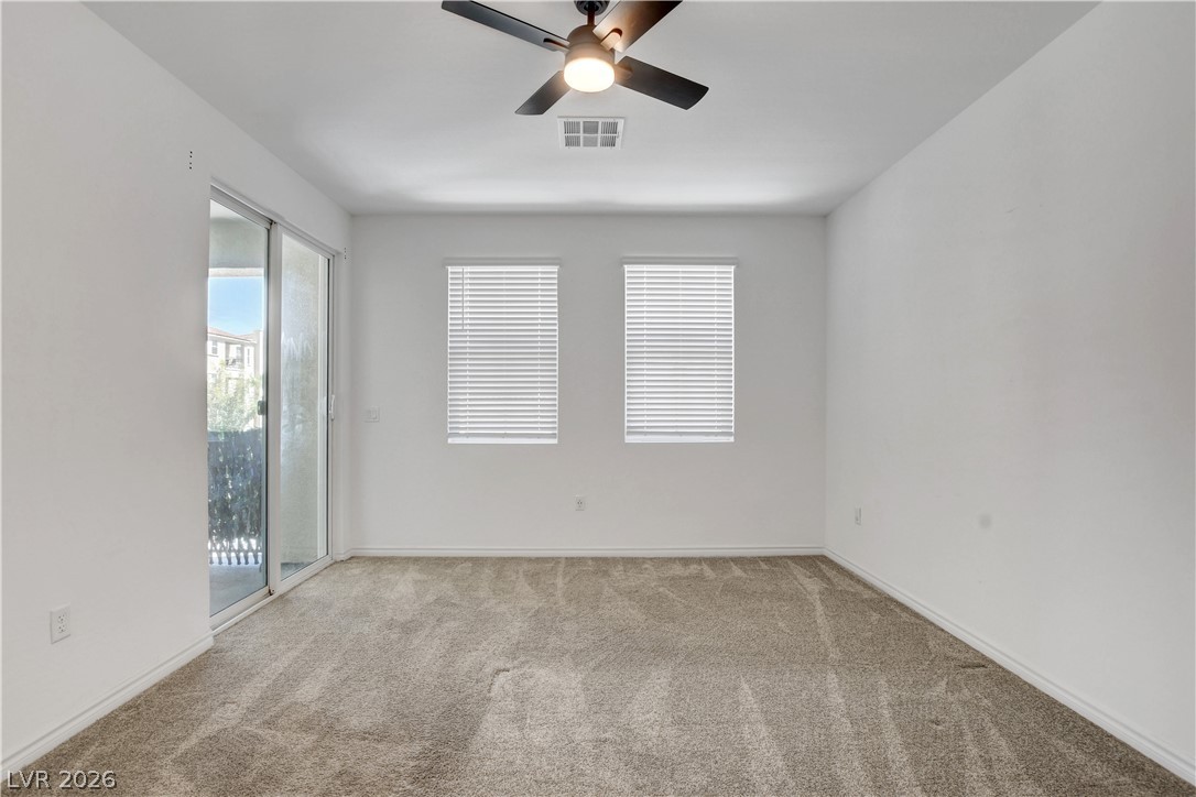 2555 Hampton Road, Unit 2207 Henderson, NV 89052 - Photo 23 of 74 A spacious, naturally illuminated room features plush carpet and direct balcony access.
