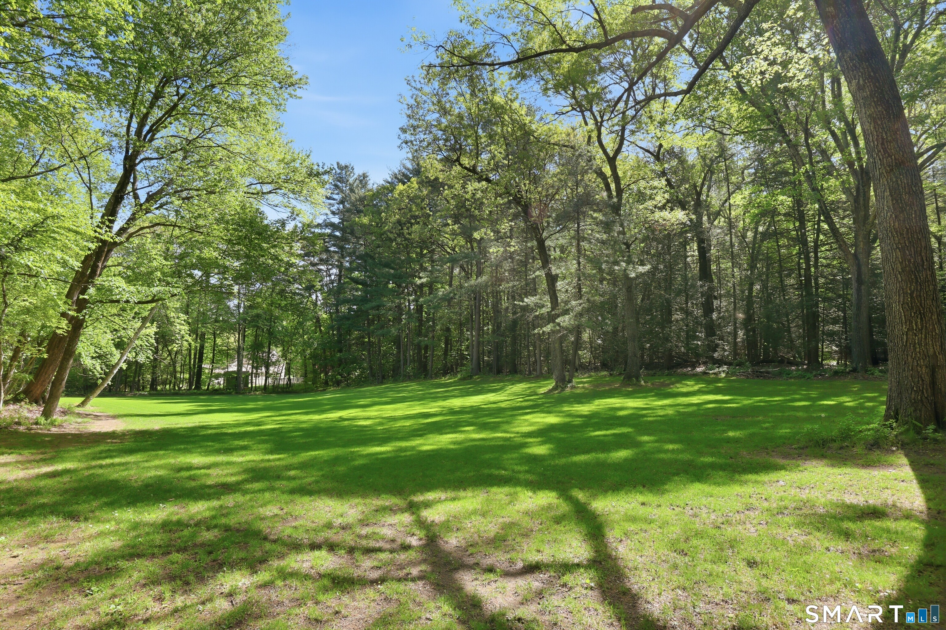 174 Canton Road Granby, CT 06035 - Photo 30 of 35 a grassy field with trees in the background
