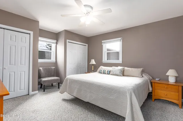 a bedroom with a bed and chair