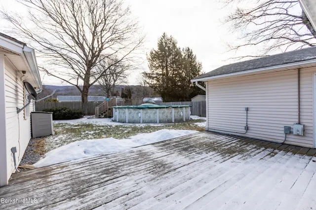 a view of a backyard with a tree