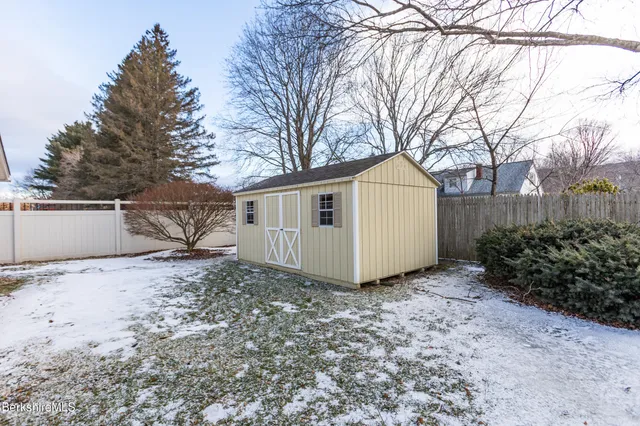 a view of a house with a yard and pathway