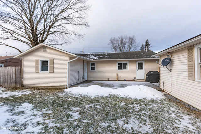 a house that has a tree in front of the house