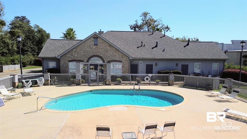 303 Wyld Palms Drive, Unit 303 Foley, AL 36535 - Photo 27 of 36 Community pool with a patio