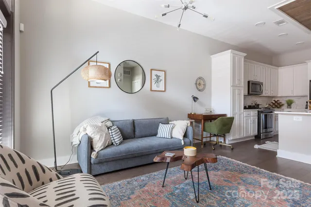 a living room with furniture and kitchen view