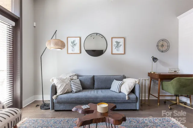 a living room with furniture a couch and wooden floor