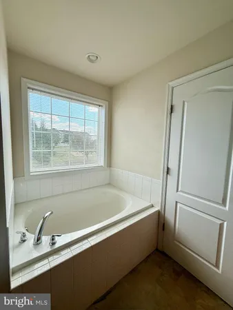 a bathroom with a bathtub and a sink