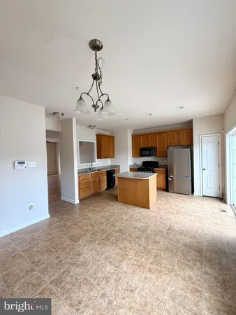a large kitchen with stainless steel appliances granite countertop a sink and cabinets
