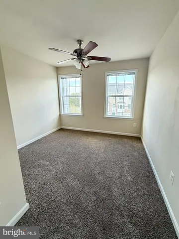 a view of room with a ceiling fan and window