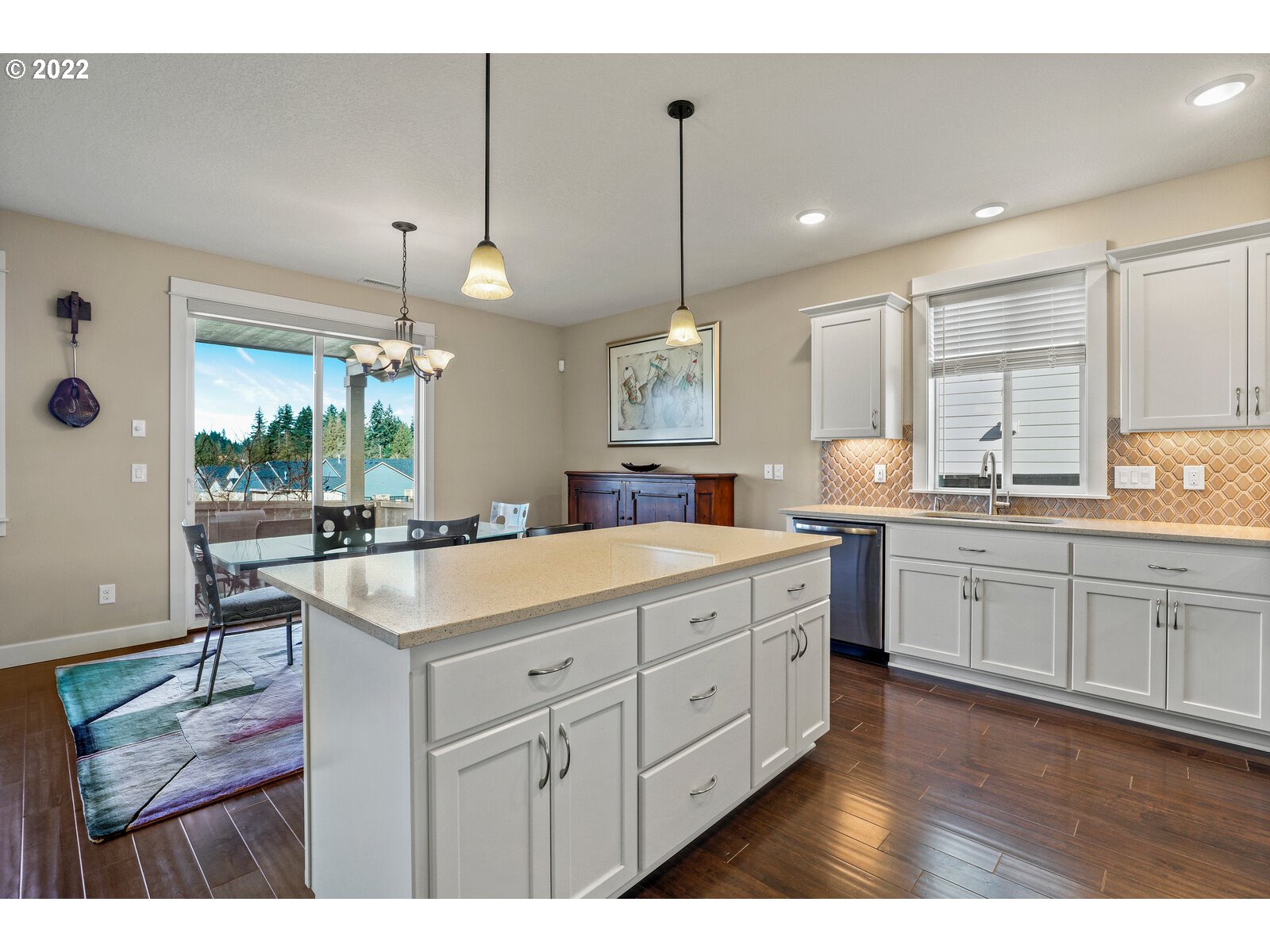 1704 Northeast 172nd Street Ridgefield, WA 98642 - Photo 12 of 31 a kitchen with kitchen island granite countertop a sink a counter space appliances and cabinets