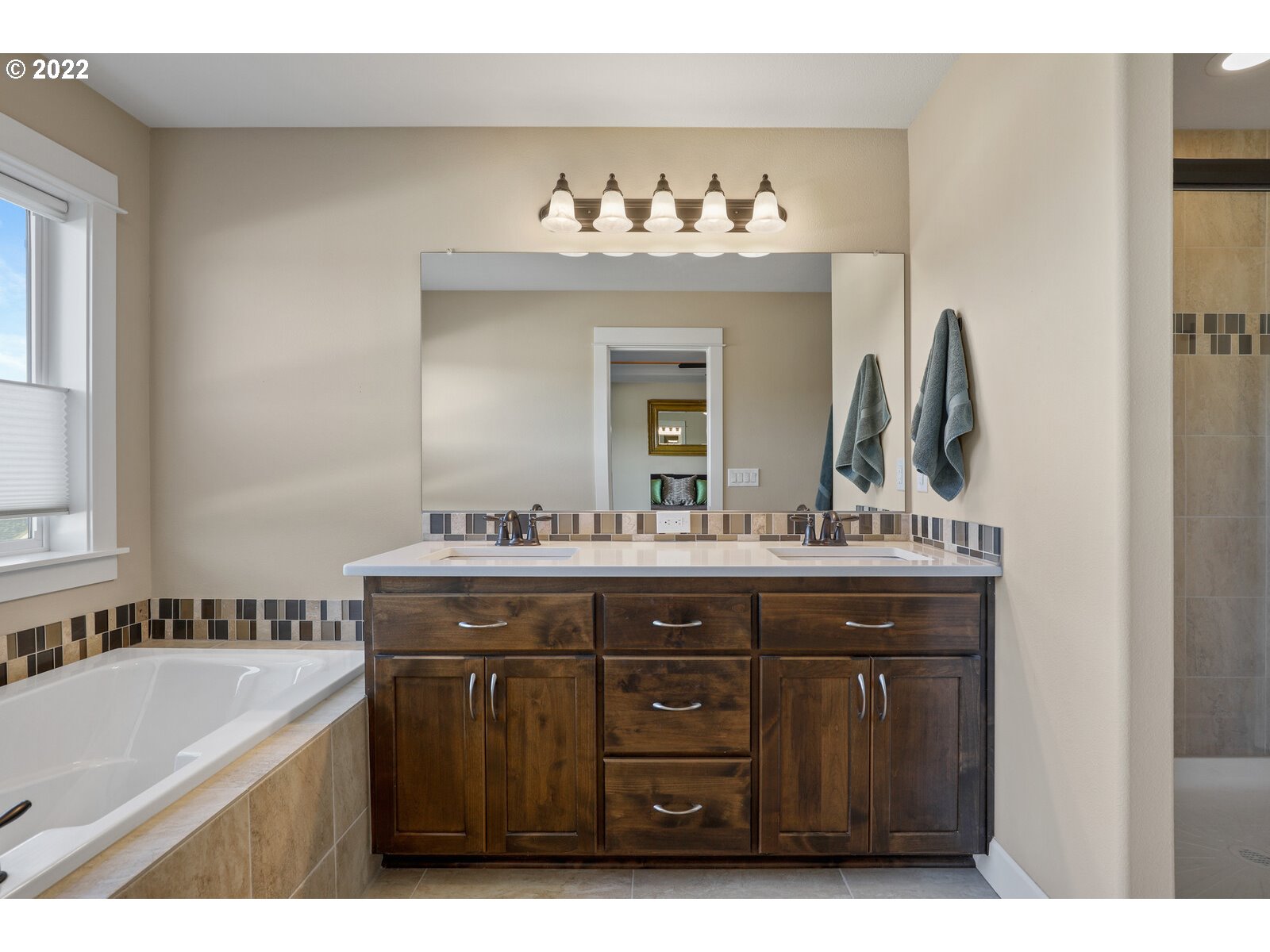 1704 Northeast 172nd Street Ridgefield, WA 98642 - Photo 21 of 31 a spacious bathroom with a sink double vanity and mirror