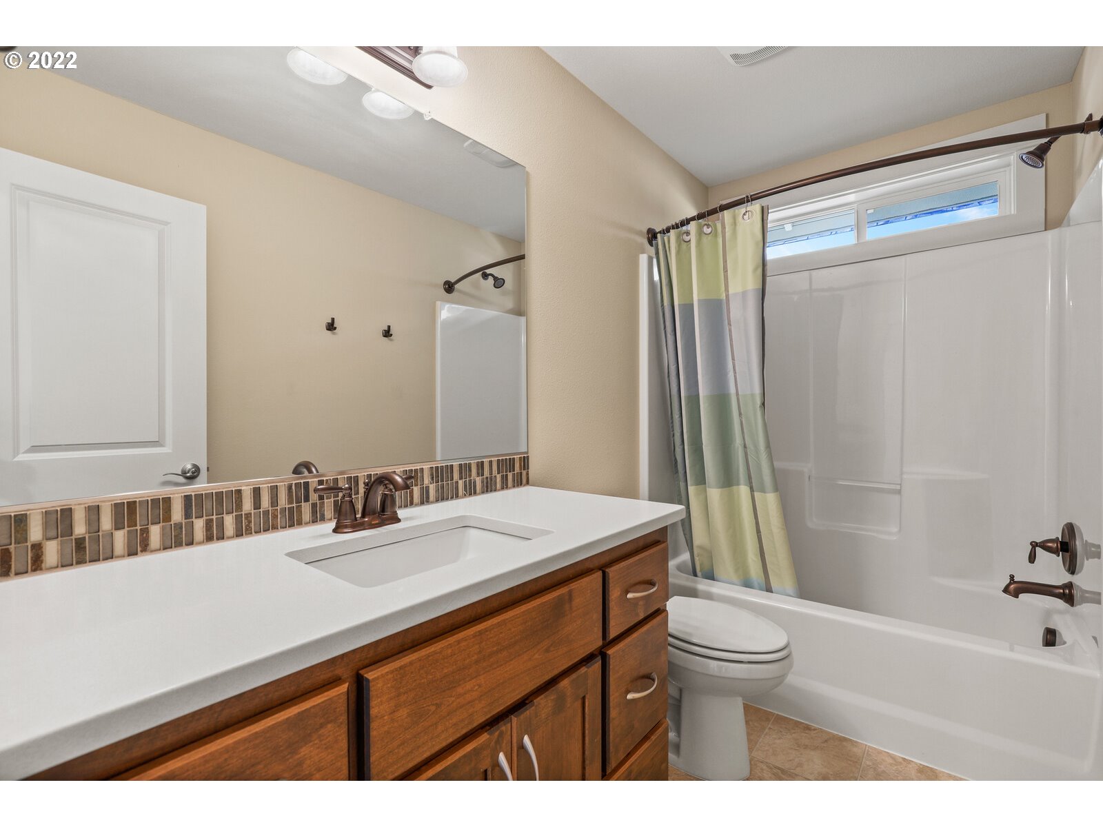 1704 Northeast 172nd Street Ridgefield, WA 98642 - Photo 26 of 31 a bathroom with a sink a toilet a mirror and shower