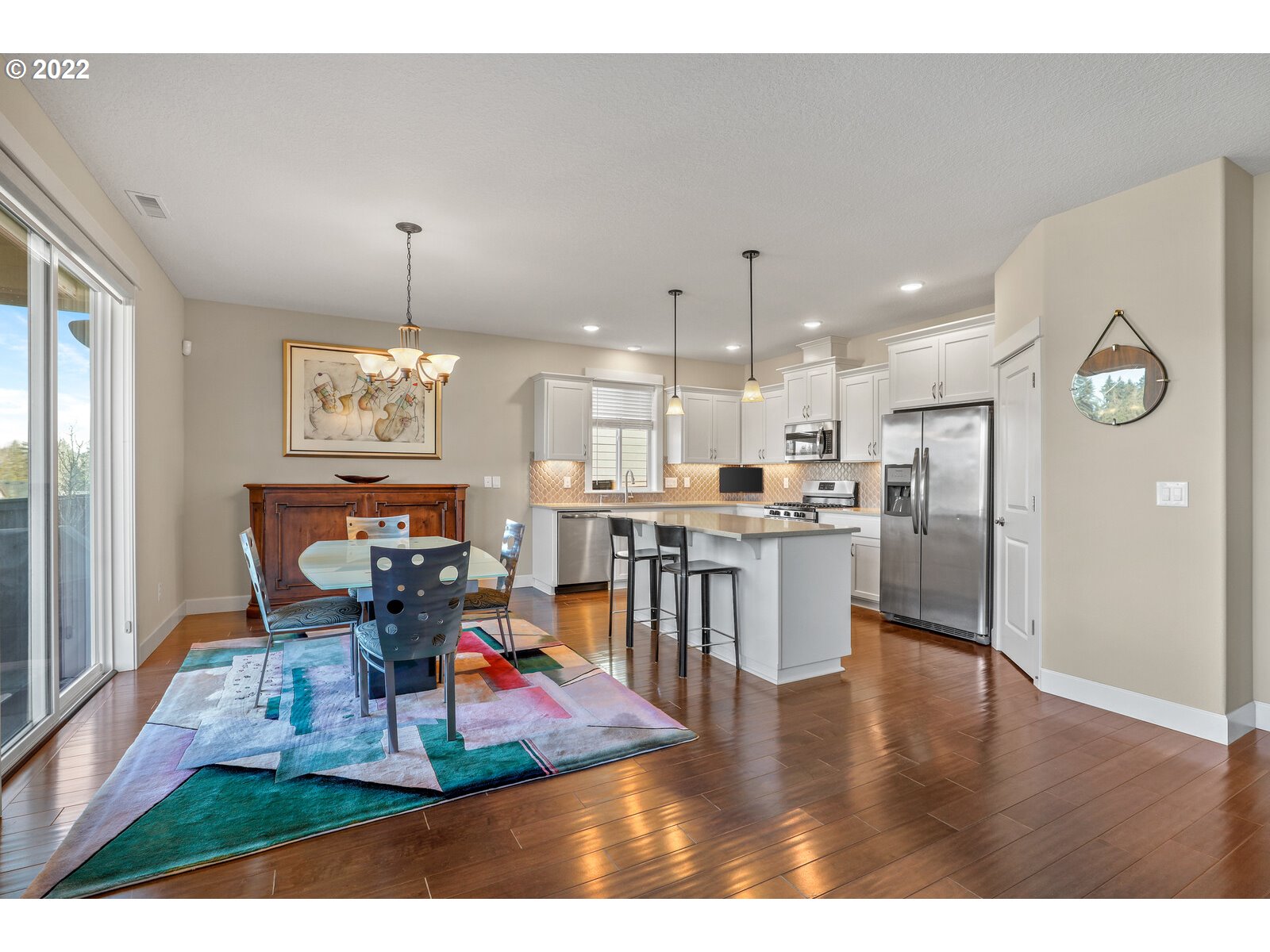 1704 Northeast 172nd Street Ridgefield, WA 98642 - Photo 5 of 31 a living room with stainless steel appliances kitchen island granite countertop furniture and a wooden floor