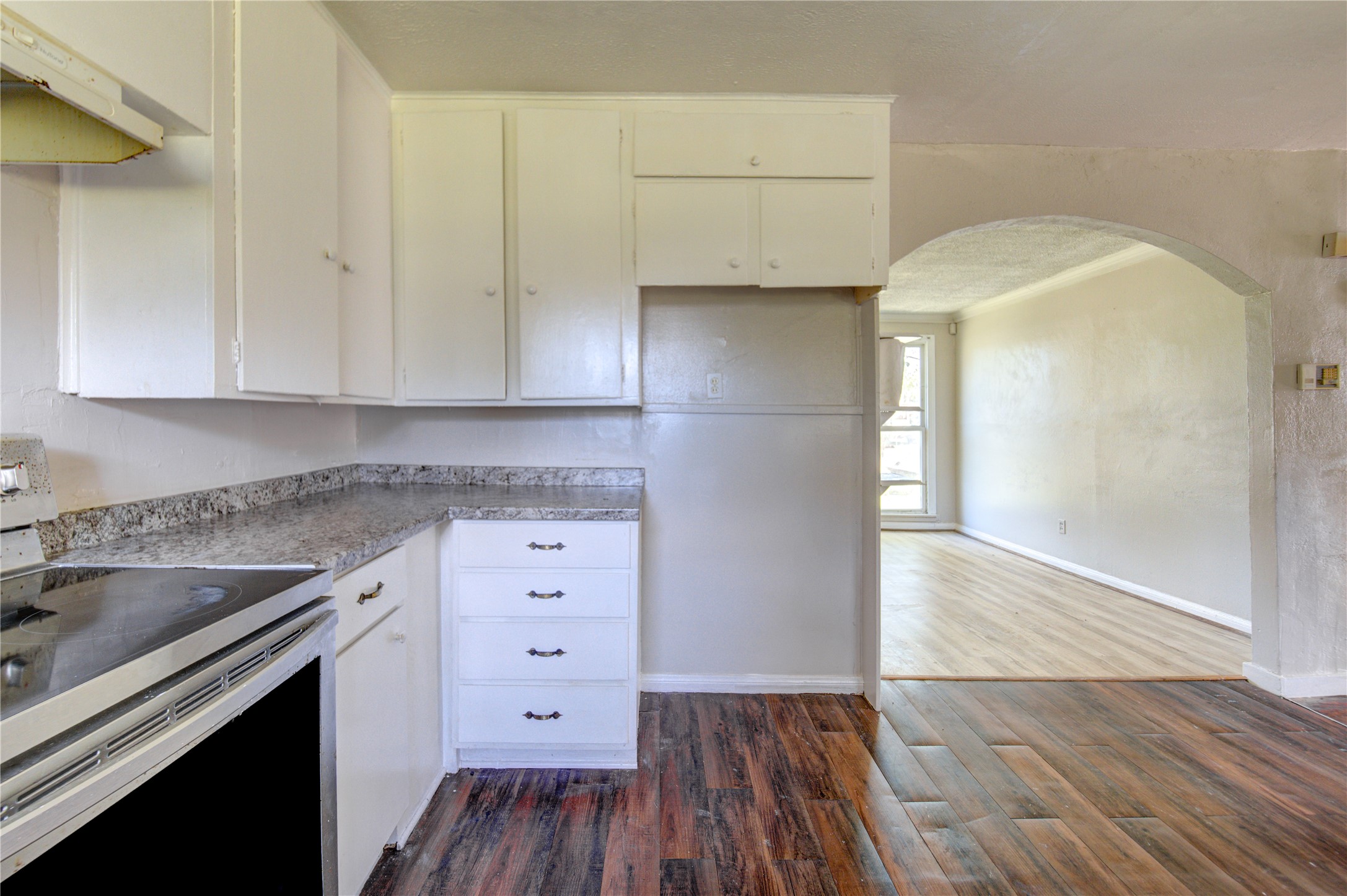 3431 Sayers Street Houston, TX 77026 - Photo 14 of 44 an empty room with wooden floor and cabinet