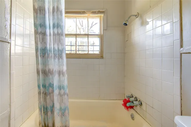 a bathroom with a bathtub and shower