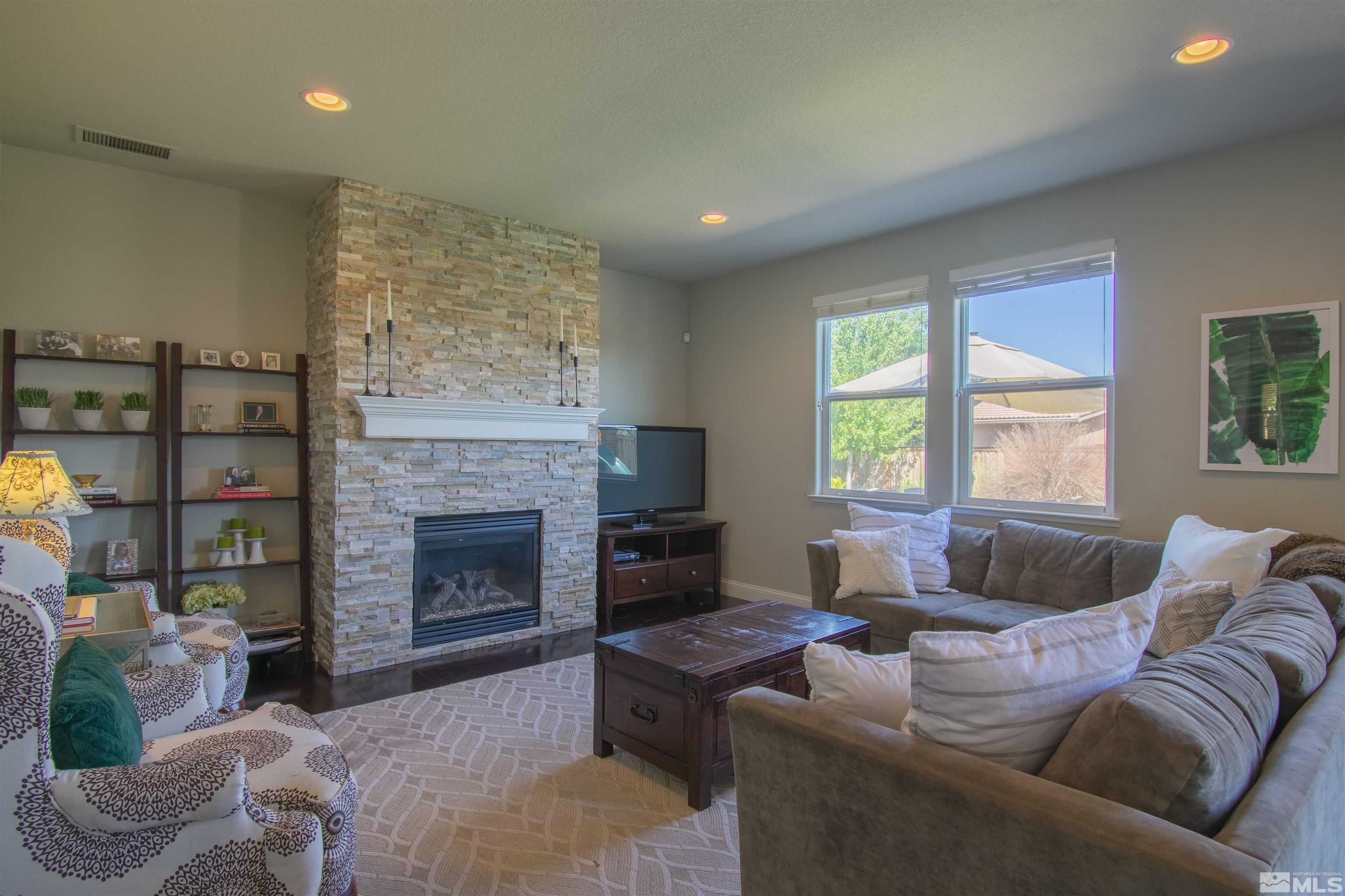 305 Pesaro Way Reno, NV 89521 - Photo 8 of 37 a living room with furniture window and a fireplace
