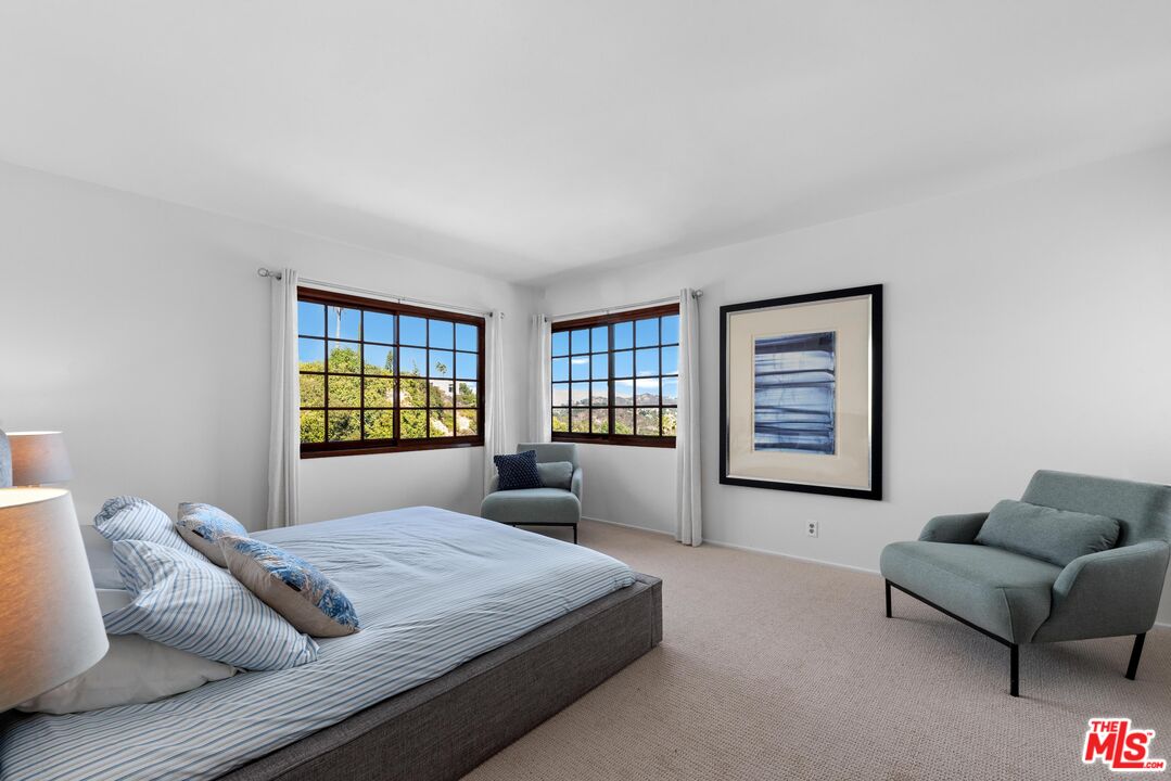 8636 Edwin Drive Los Angeles, CA 90046 - Photo 12 of 25 a bedroom with a bed couch and window