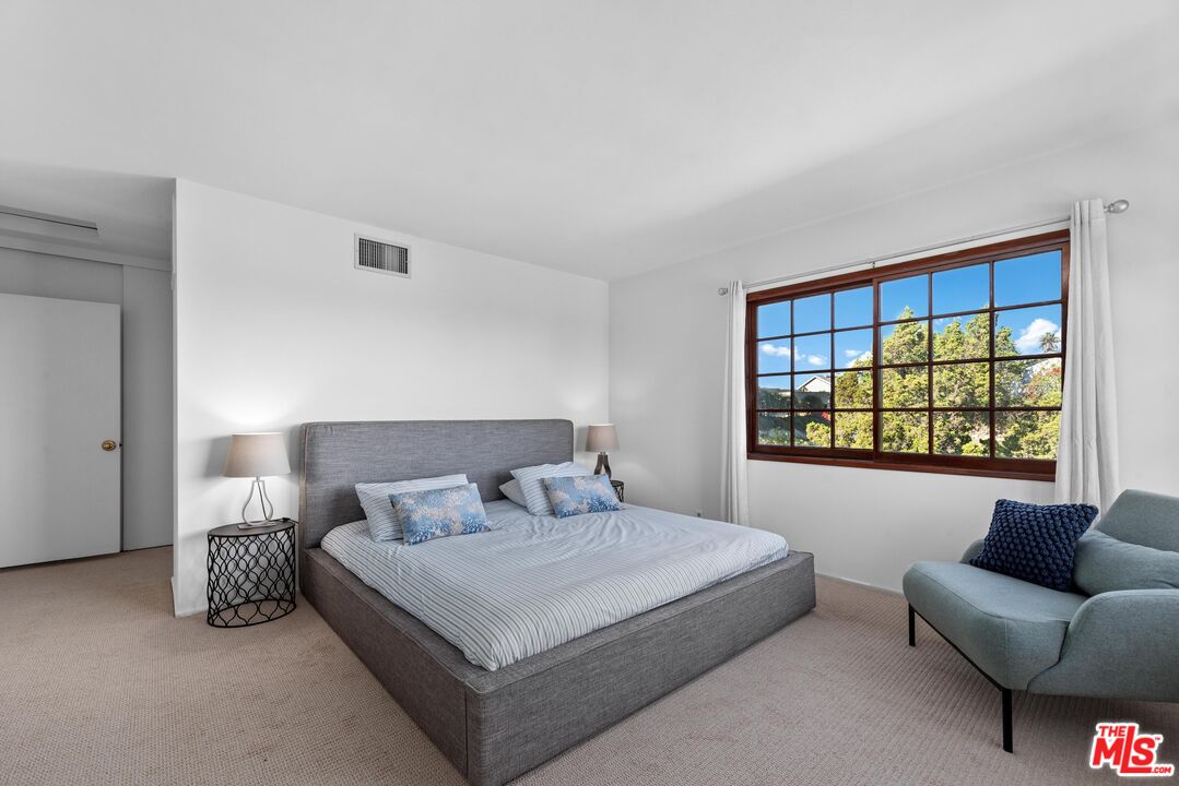 8636 Edwin Drive Los Angeles, CA 90046 - Photo 14 of 25 a bedroom with a bed couch and a window