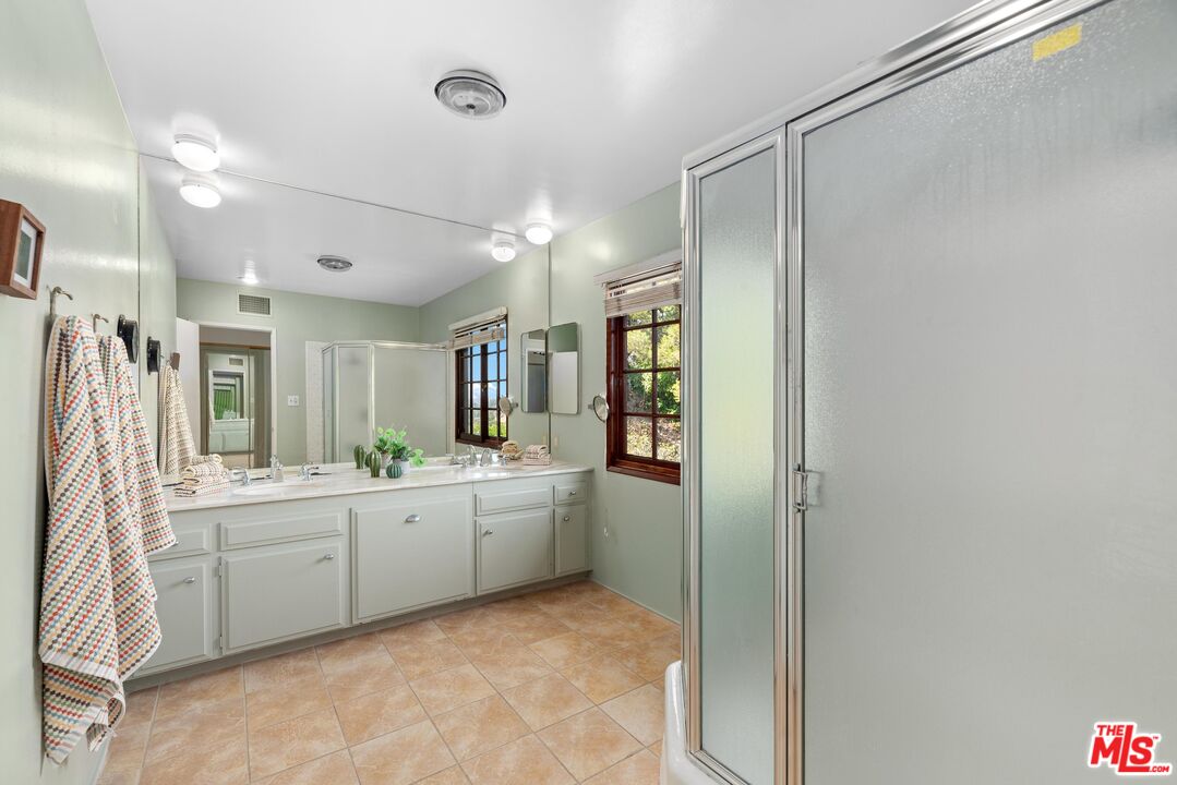 8636 Edwin Drive Los Angeles, CA 90046 - Photo 15 of 25 a large bathroom with a glass door shower sink and mirror