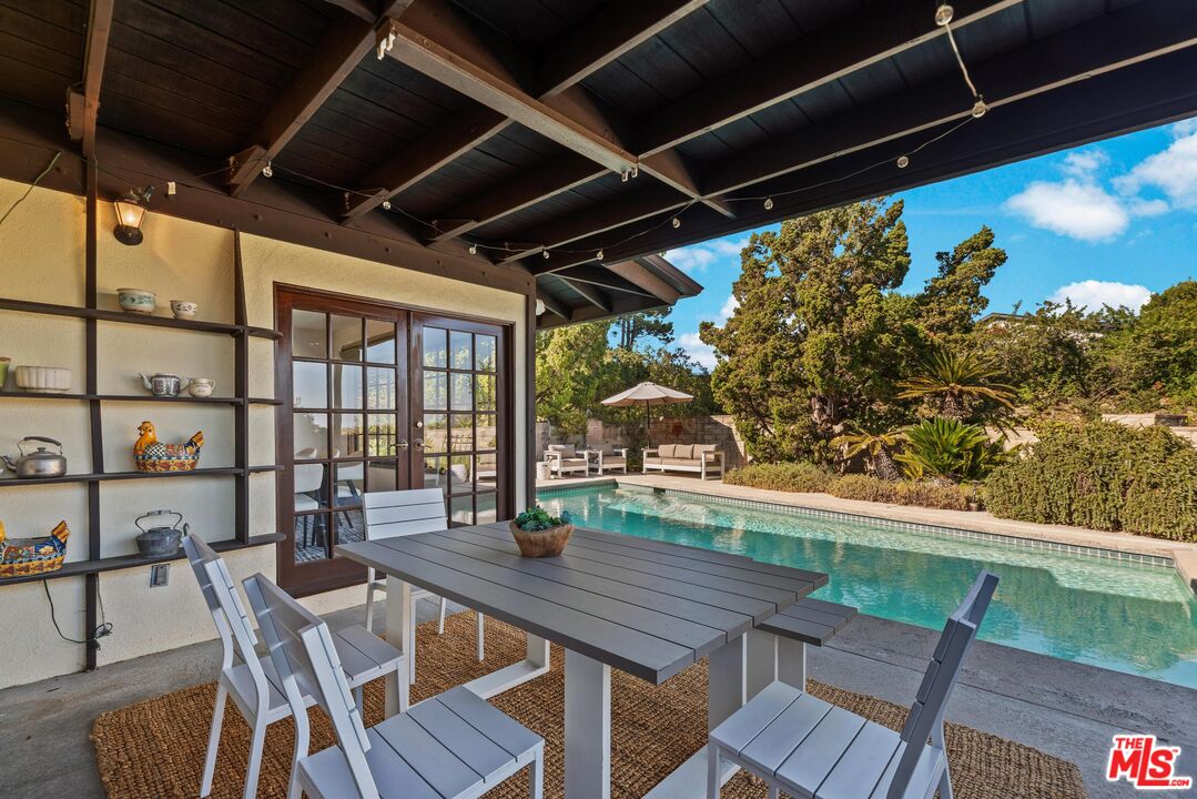 8636 Edwin Drive Los Angeles, CA 90046 - Photo 21 of 25 a view of a porch with furniture and a yard
