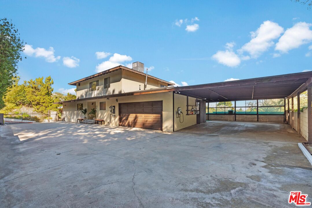 8636 Edwin Drive Los Angeles, CA 90046 - Photo 23 of 25 a view of a house with a yard and garage
